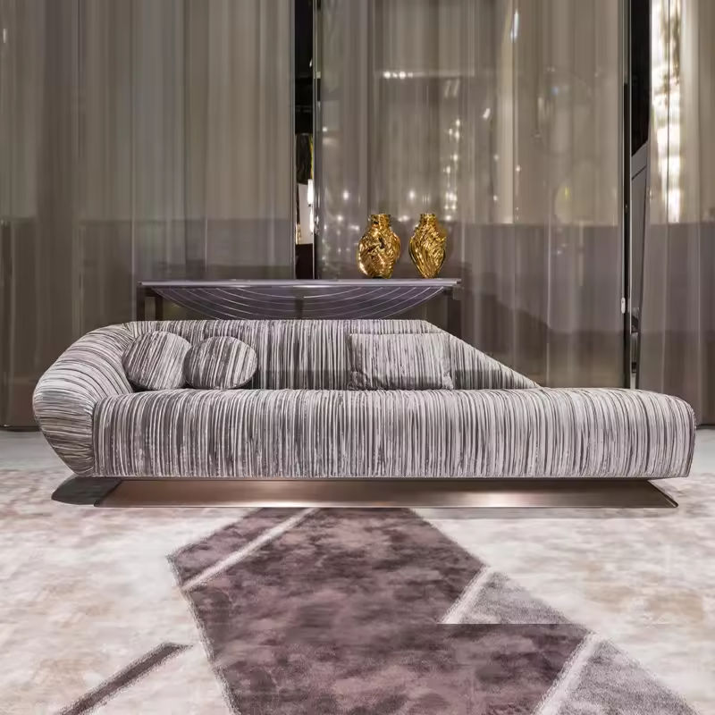 Modern gray sofa in a stylish room with a rug and decorative vases.