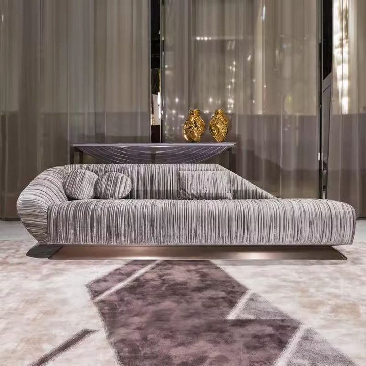 Modern gray sofa in a stylish room with a rug and decorative vases.
