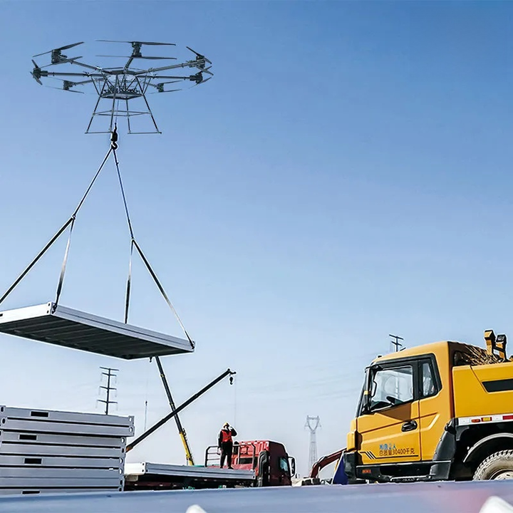 Drone lifting a large panel above a truck on a clear day