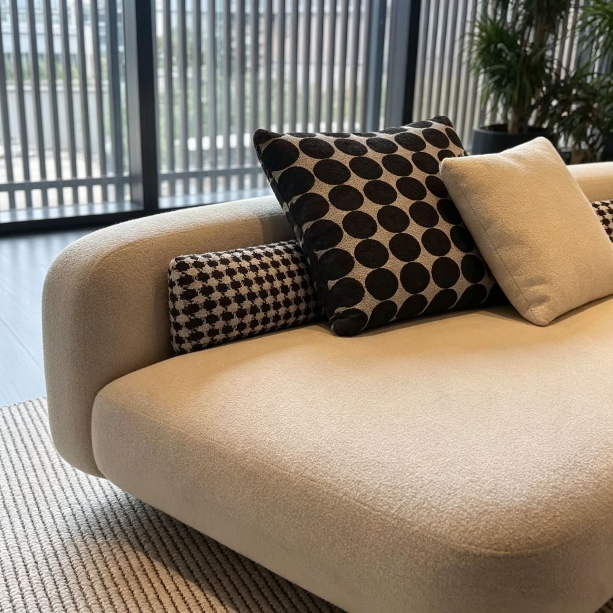 Beige sofa with patterned cushions in a modern living room setting