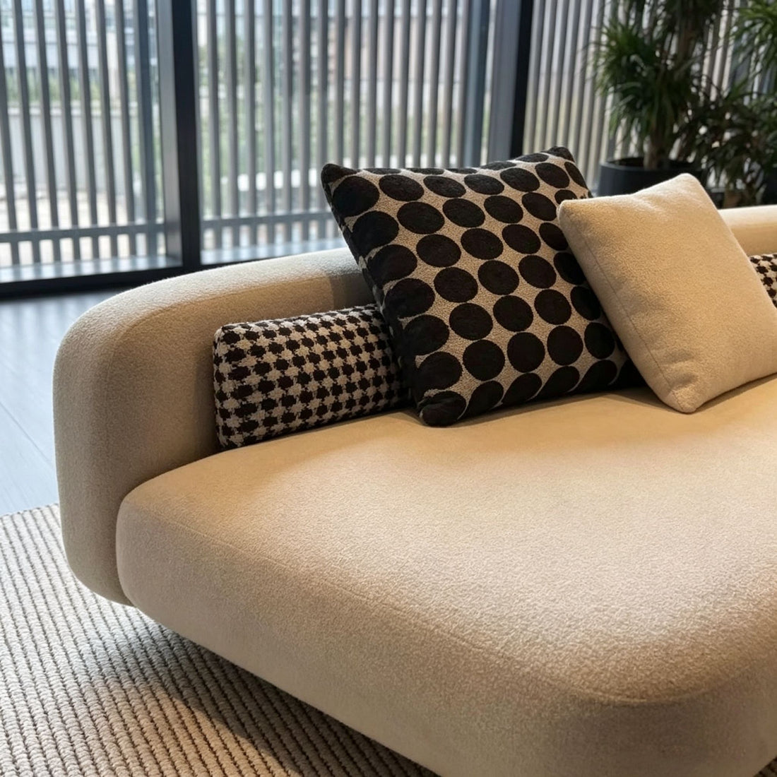 Beige sofa with patterned cushions in a modern living room setting