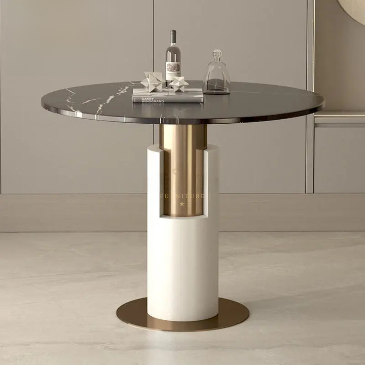 Modern round dining table with marble top and gold and white base in a neutral setting