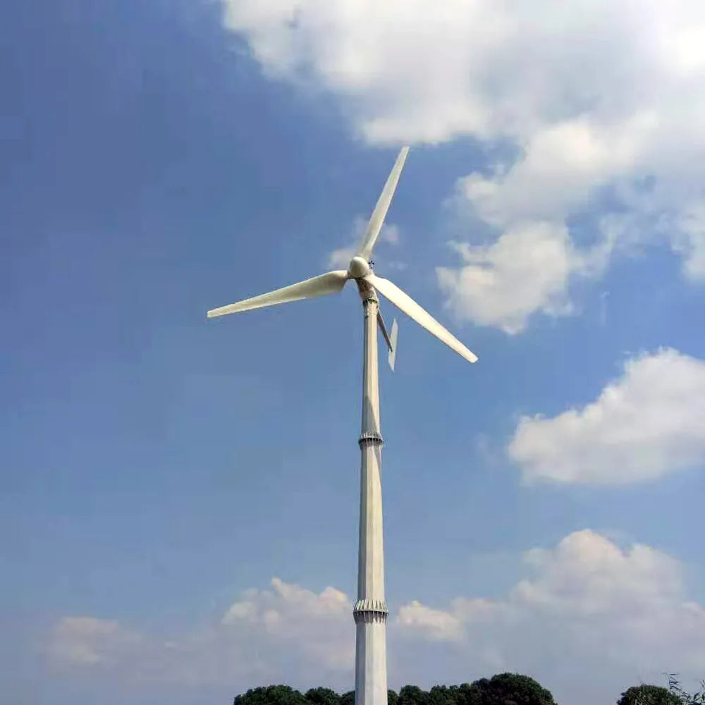 Wind turbine against a blue sky with some clouds