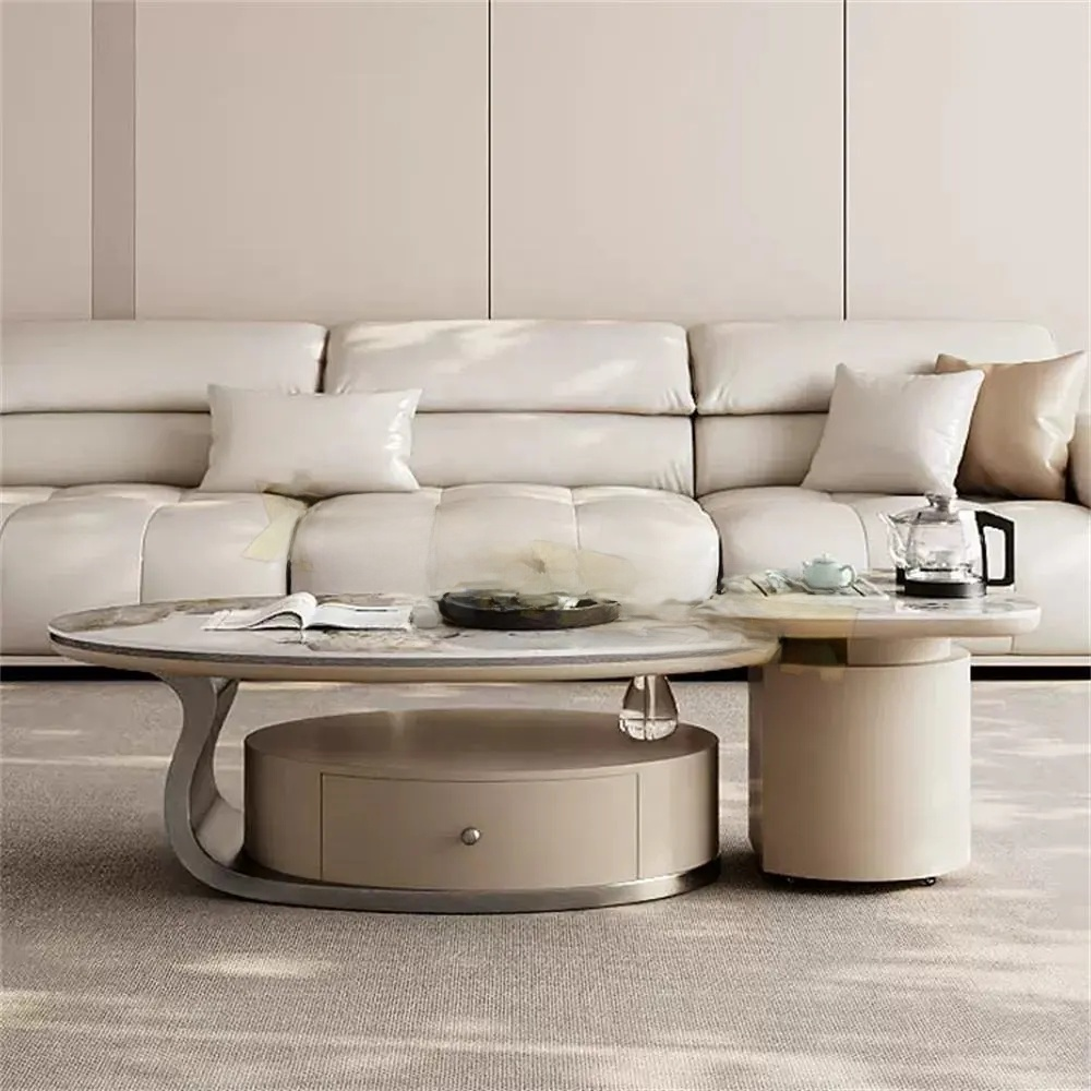 Modern living room with a beige sectional sofa and round coffee table.