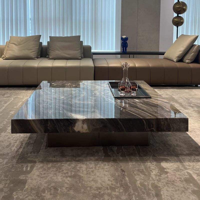Modern living room with a marble coffee table and brown sectional sofa.