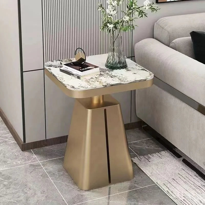 Gold side table with marble top in a living room setting