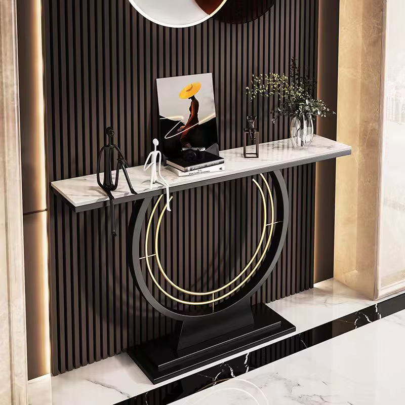 Modern console table with marble top and decorative items against a striped wall.