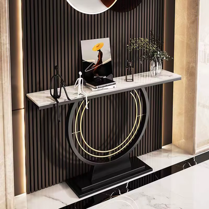 Modern console table with marble top and decorative items against a striped wall.