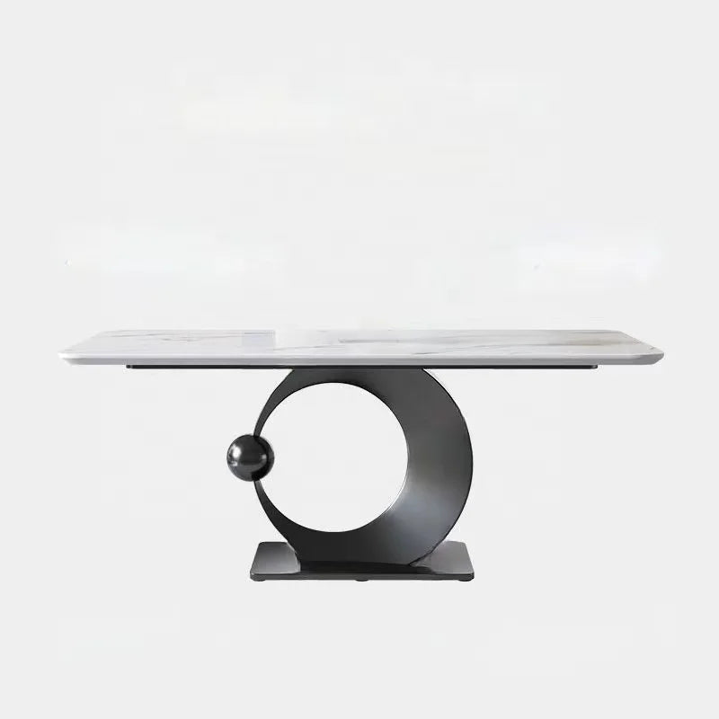 Modern dining table with marble top and unique metal base on a white background