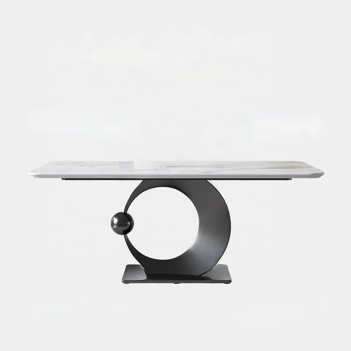 Modern dining table with marble top and unique metal base on a white background