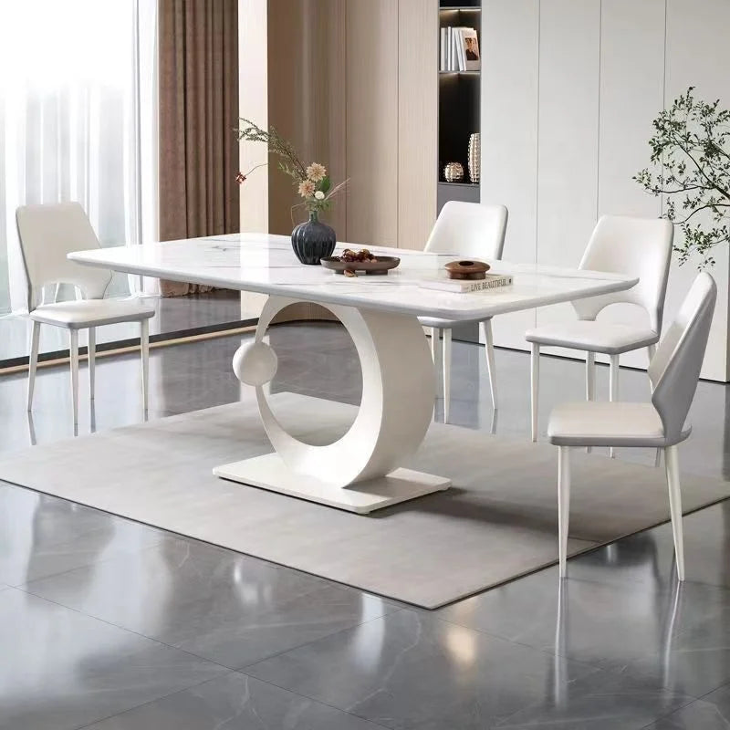 Modern dining room with a white marble table and chairs.