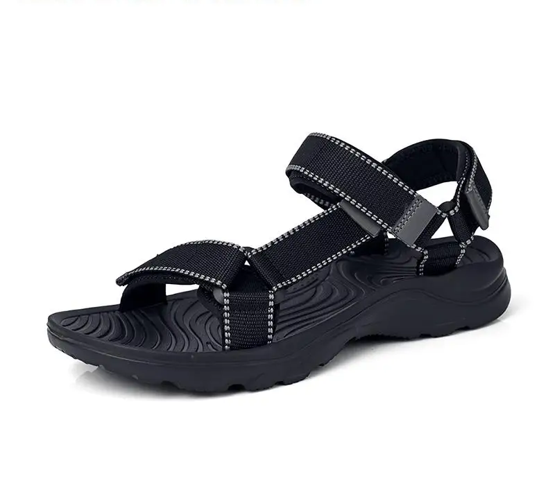 A single black athletic sandal with adjustable woven straps and a textured sole, shown from a side profile on a white background.