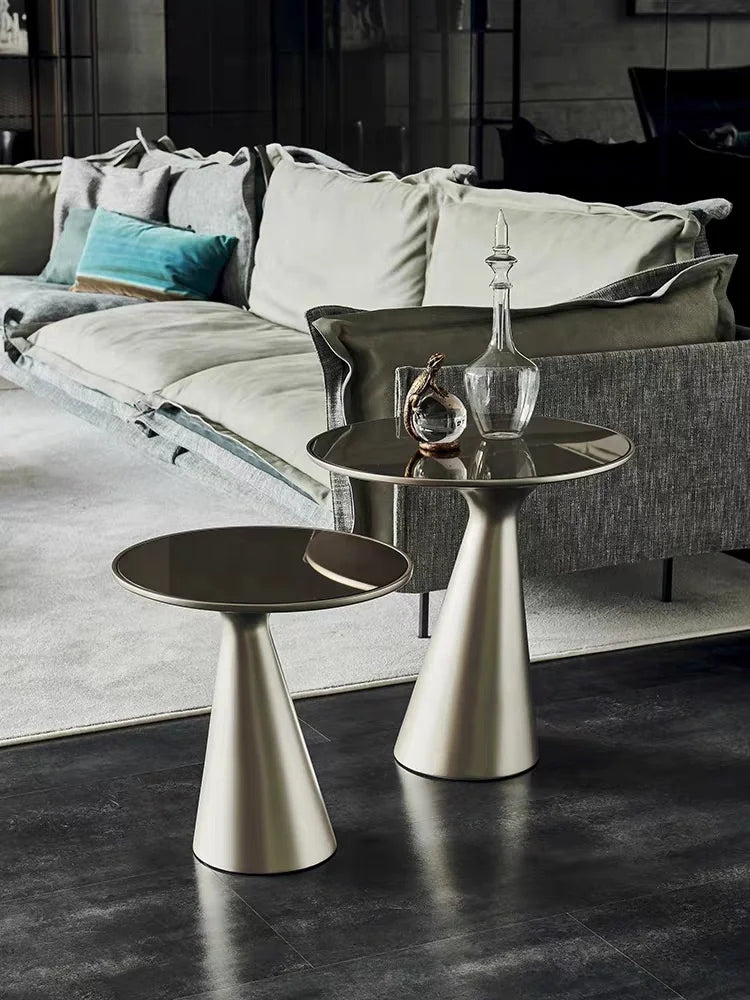 Modern living room with a gray sofa and metallic side tables.