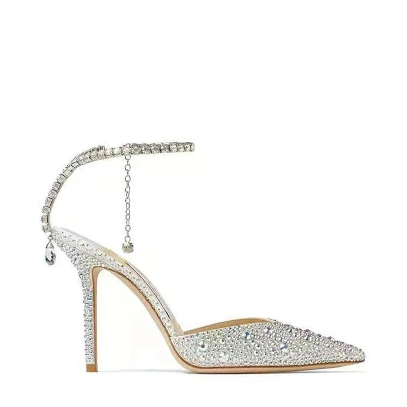 High-heeled shoe with crystal embellishments on a white background