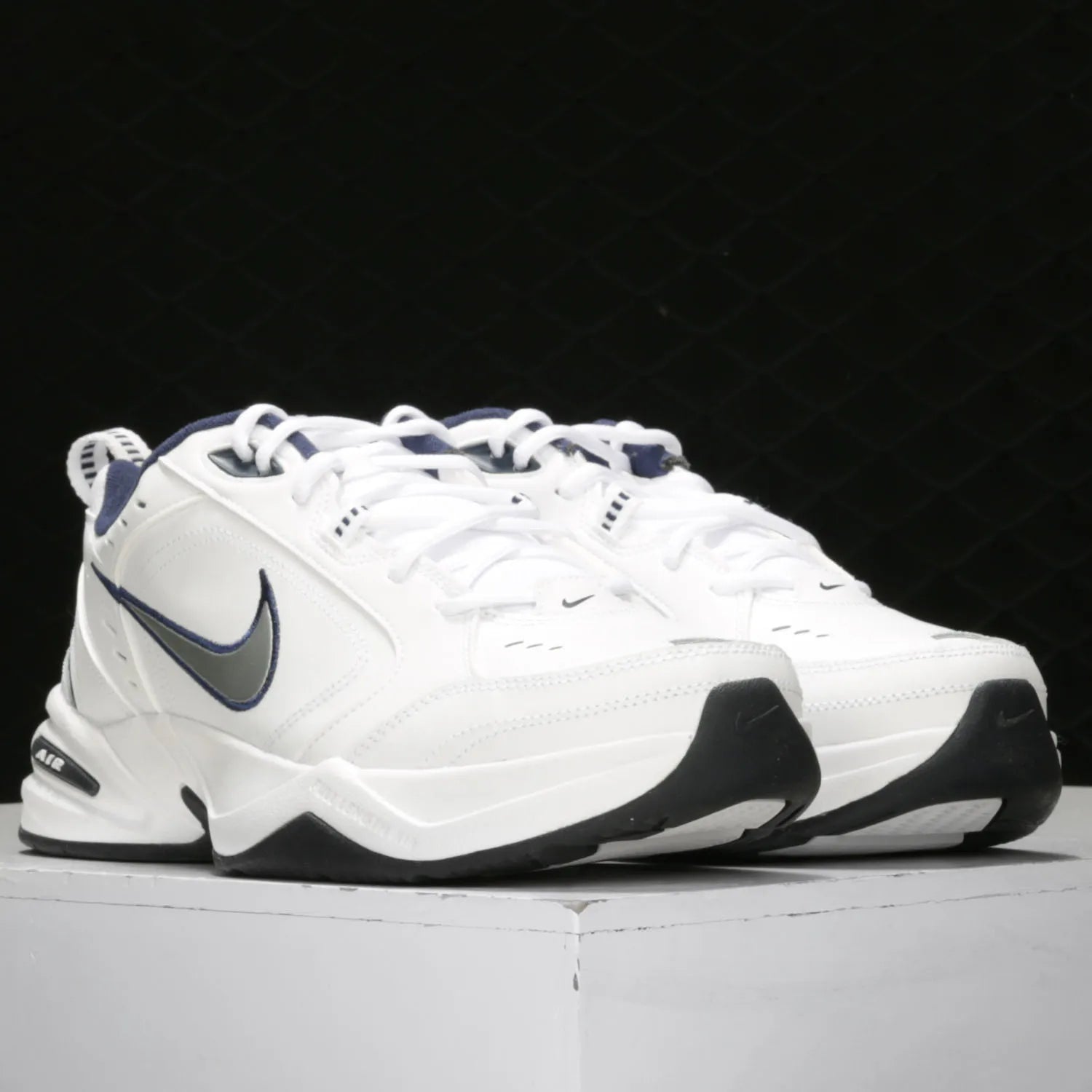 White Nike sneakers with black and gray accents on a white background