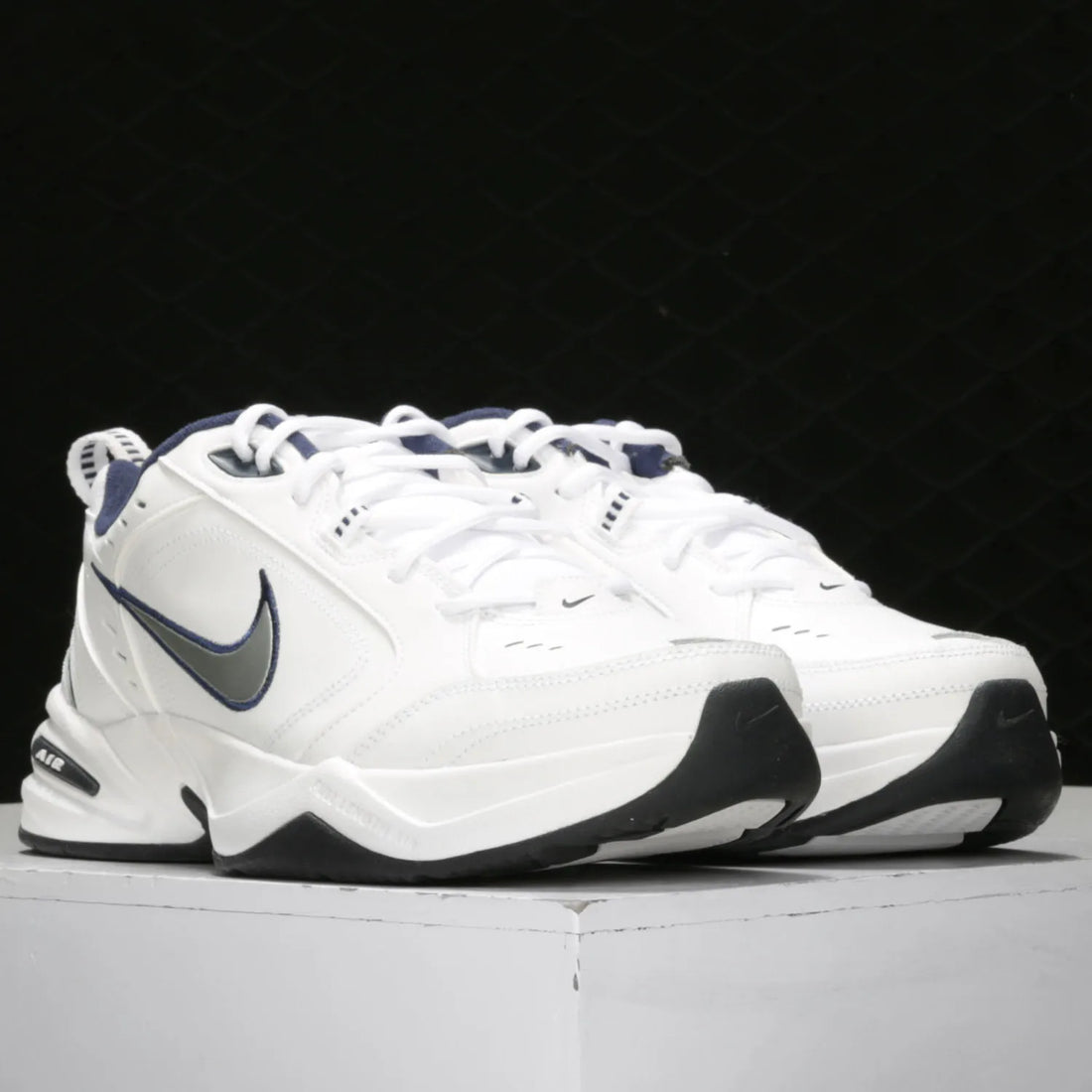White Nike sneakers with black and gray accents on a white background