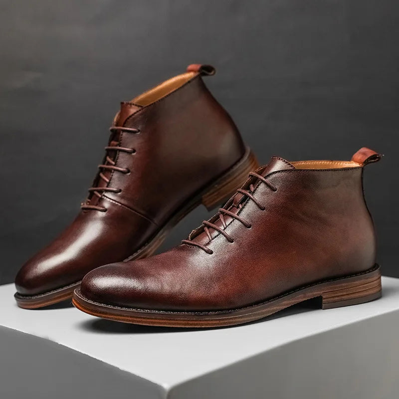 Pair of brown leather boots on a gray background
