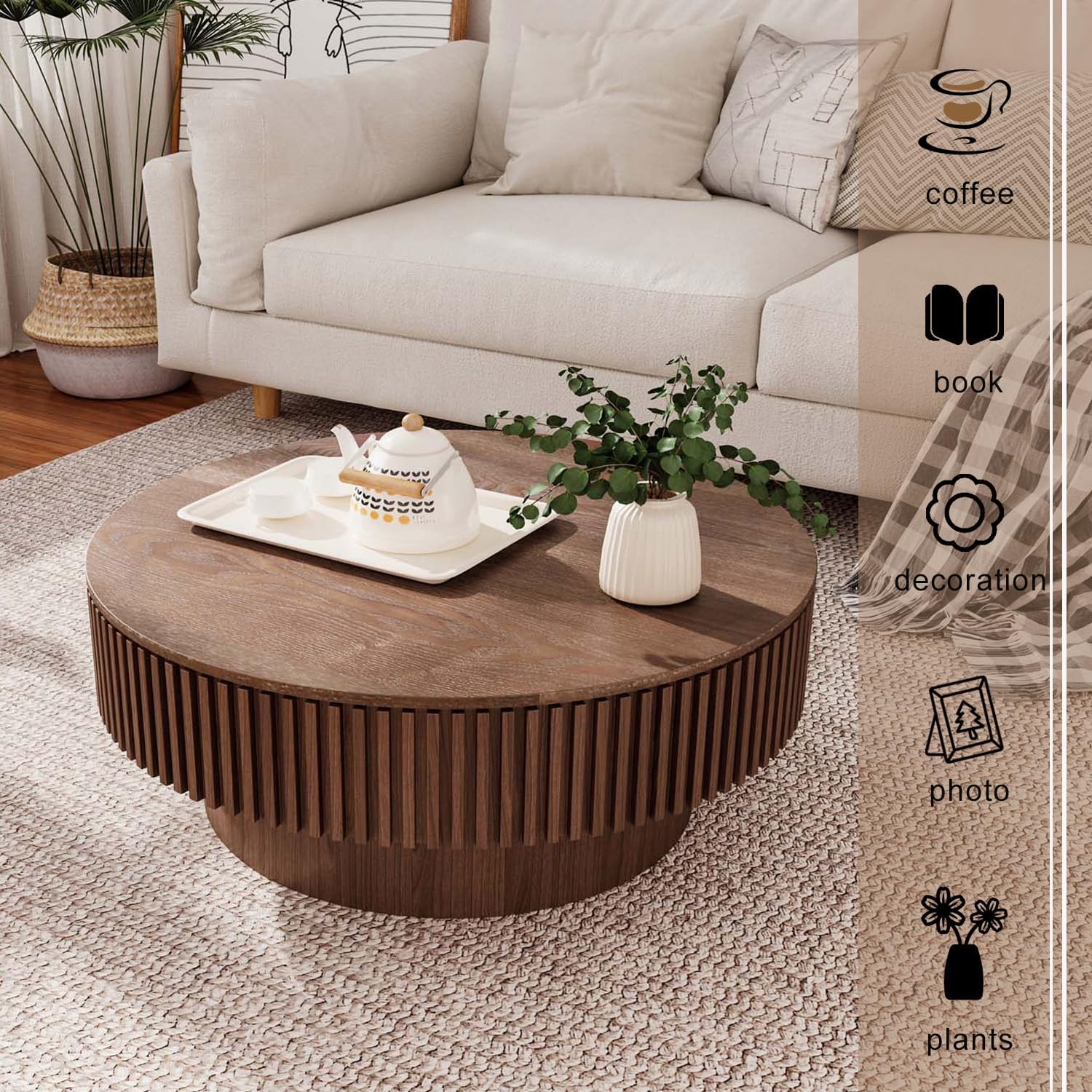 Round wooden coffee table with decorative items in a living room setting