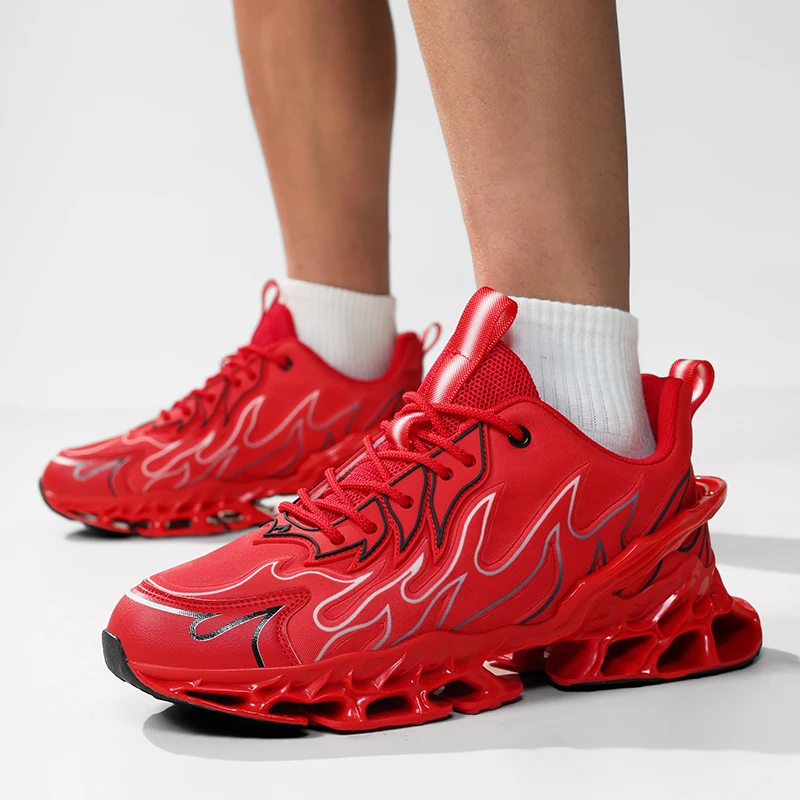Red sneakers with flame design worn by a person on a light gray background