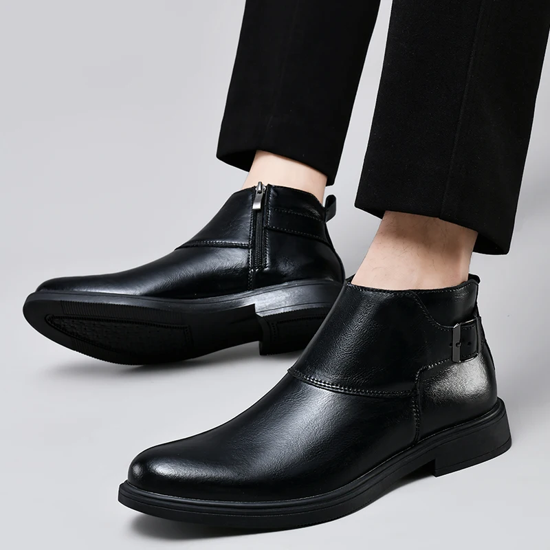 Black leather shoes worn with black pants on a light gray background