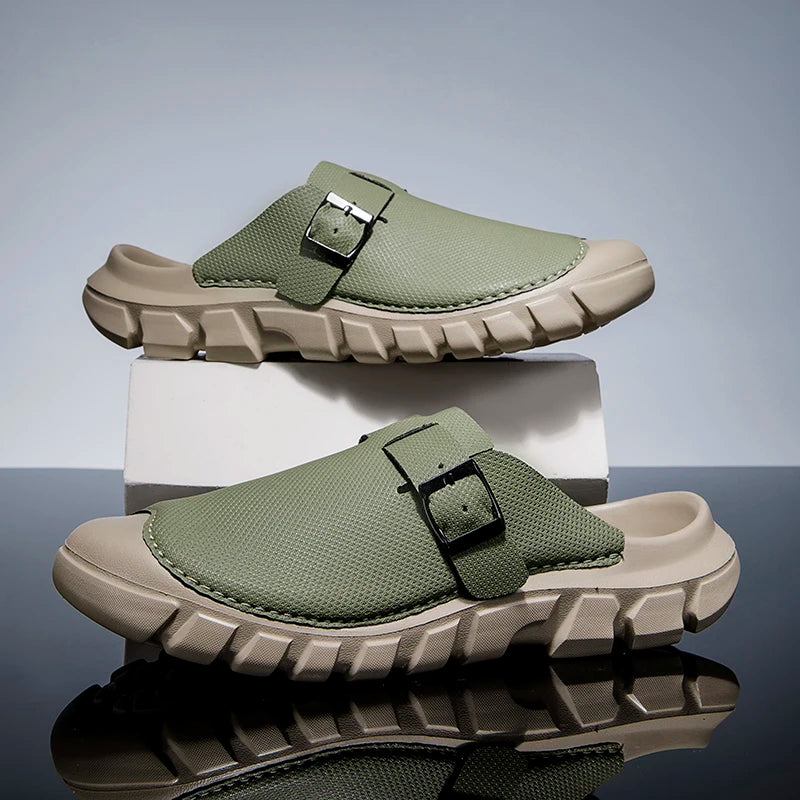 Green clogs with beige soles on a reflective surface and gray background