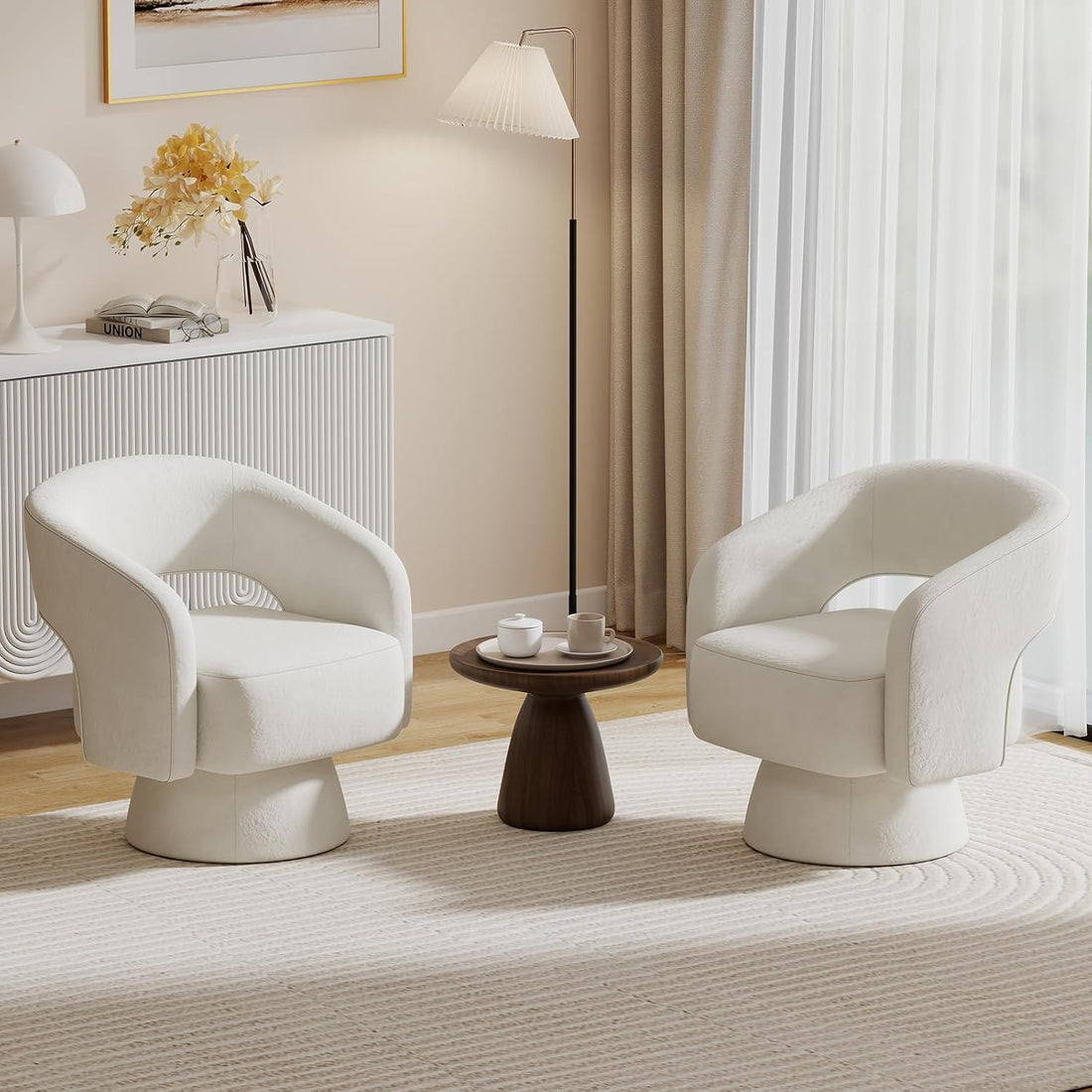 Modern living room with two white chairs and a small round table.