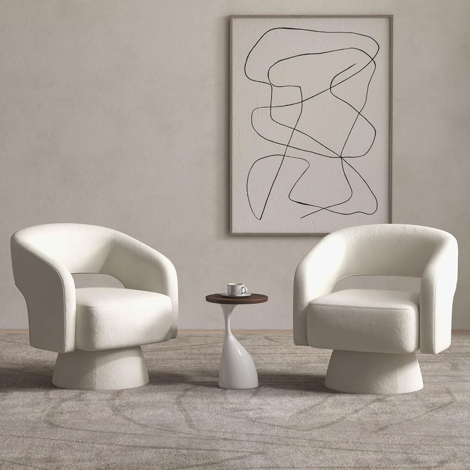 Modern living room with two white chairs and a small table, featuring abstract art on the wall.