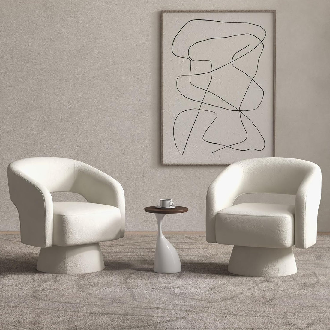 Modern living room with two white chairs and a small table, featuring abstract art on the wall.