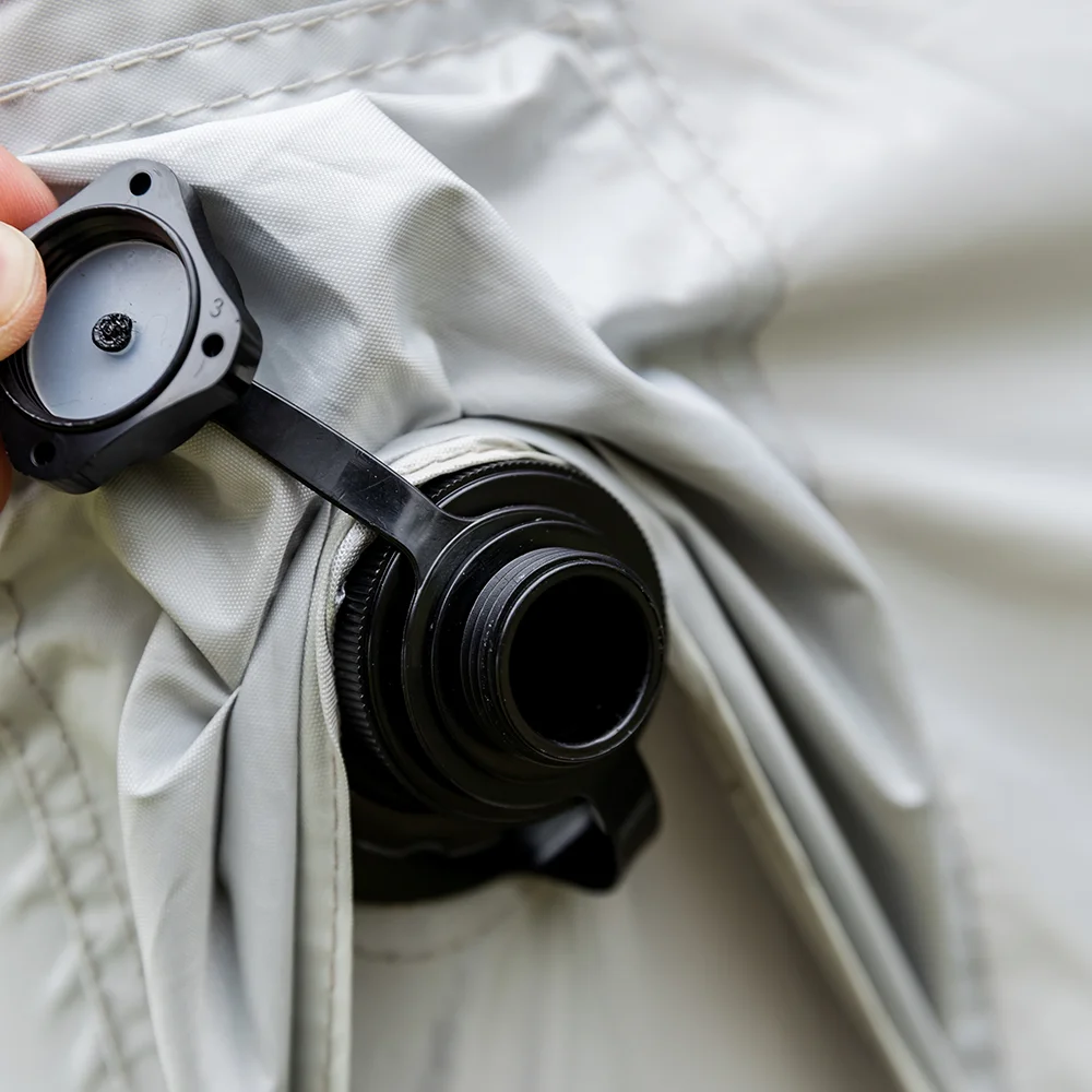 Close-up of a camera lens attached to a beige fabric background
