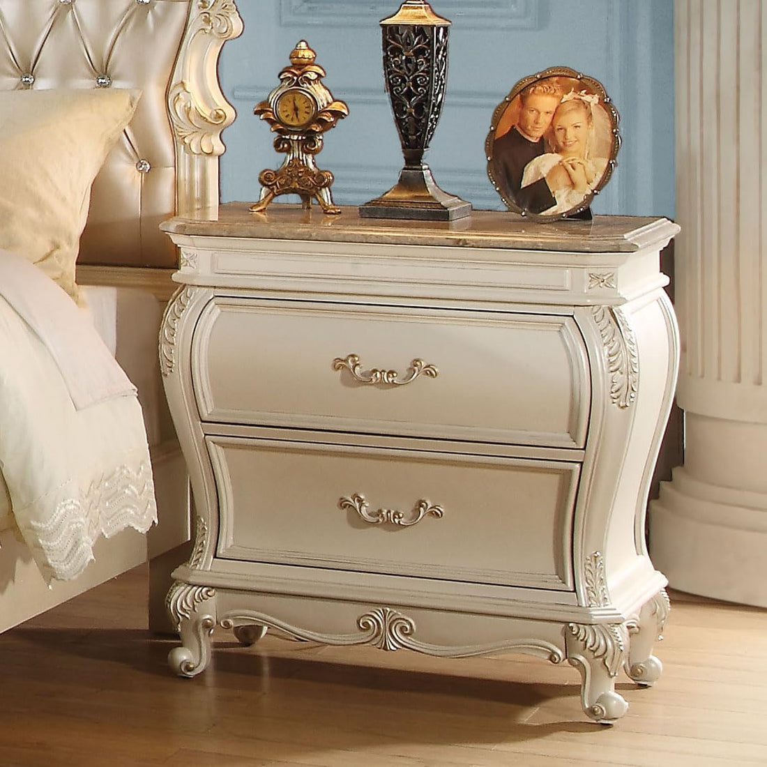 Decorative nightstand with ornate design in a bedroom setting
